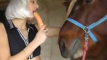 Pretty woman tastes a horse's cock